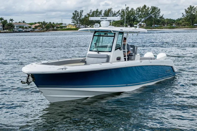 Slide: The Image of 2023 Boston Whaler 330 Outrage boat cruising on a calm waterway. - 9