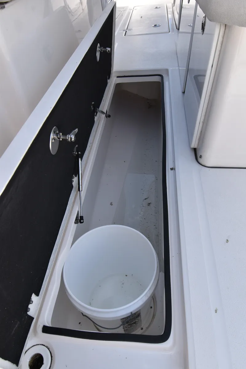 Slide: The Image of 2021 Sea Fox 368 boat storage compartment with open hatch and bucket. - 14