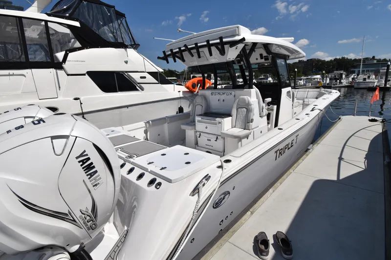 Slide: The Image of 2021 Sea Fox 368 boat docked, featuring Yamaha engines and spacious deck. - 2