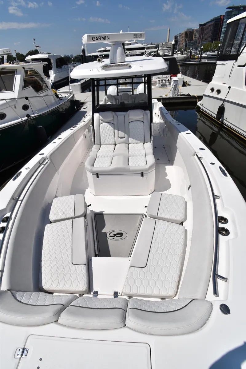 Slide: The Image of 2021 Sea Fox 368 boat with spacious seating, docked among other vessels. - 3