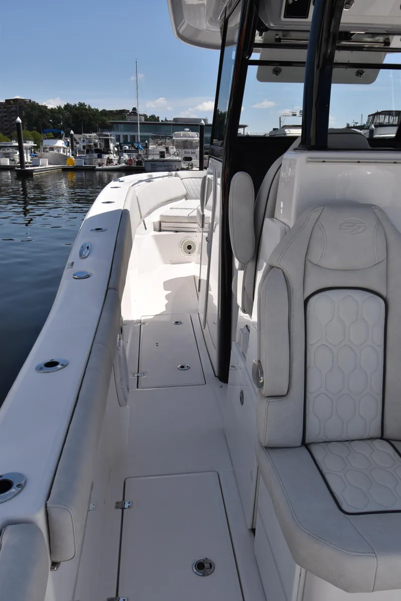 Slide: The Image of 2021 Sea Fox 368 boat interior, featuring sleek white seating and spacious deck design. - 6