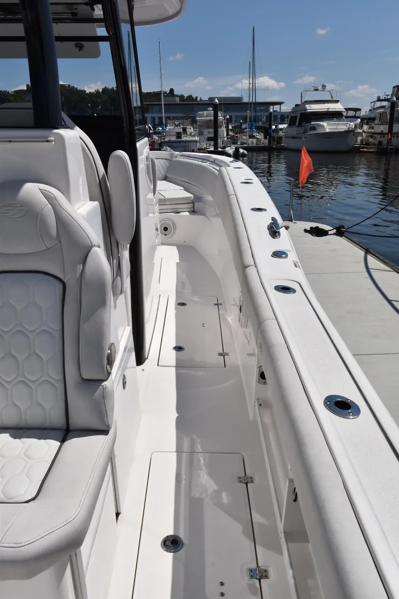 Slide: The Image of 2021 Sea Fox 368 boat docked, showcasing sleek seating and spacious deck design. - 7