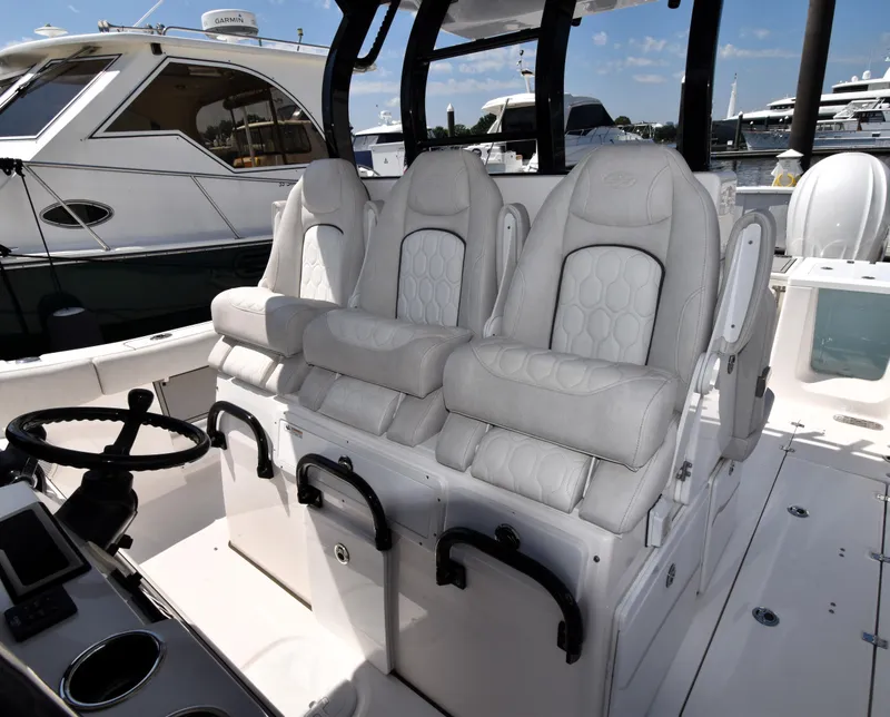 Slide: The Image of 2021 Sea Fox 368 boat interior with three luxurious white seats at the helm. - 8