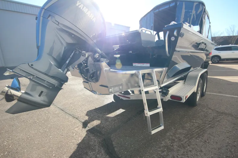 Slide: The Image of 2025 Weldcraft 210 Revolution Soft Top boat with Yamaha engine, parked on a trailer. - 10