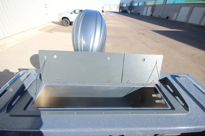 Slide: The Image of 2025 Weldcraft 210 Revolution Soft Top boat detail, featuring open storage compartment. - 14