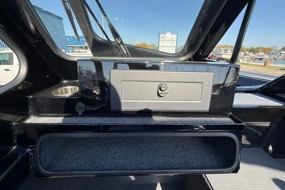 Slide: The Image of Interior view of 2025 Weldcraft 210 Revolution boat, featuring storage compartments and sleek design. - 30