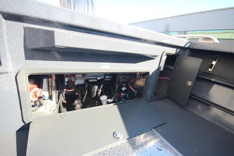 Slide: The Image of 2025 Weldcraft 210 Revolution Soft Top F200XB boat interior compartment view. - 17