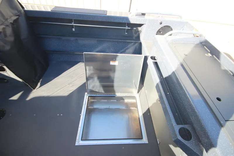Slide: The Image of 2025 Weldcraft 210 Revolution Soft Top boat interior with open storage compartment. - 18