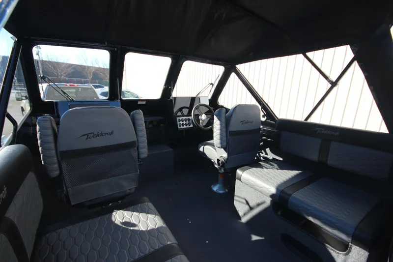 Slide: The Image of Interior of 2025 Weldcraft 210 Revolution Soft Top boat, featuring spacious seating and modern design. - 20