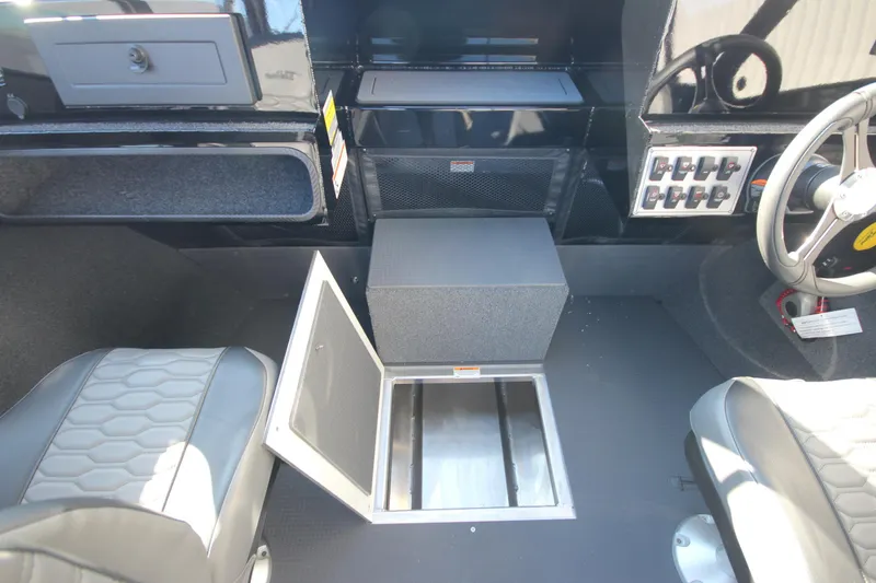 Slide: The Image of Interior of 2025 Weldcraft 210 Revolution boat, featuring seating and storage compartments. - 29
