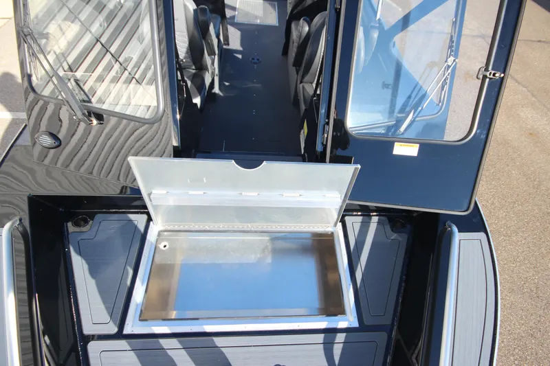Slide: The Image of 2025 Weldcraft 210 Revolution Soft Top boat interior with open storage compartment. - 32