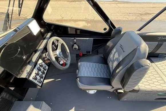 Slide: The Image of Interior of 2025 Weldcraft 210 Revolution boat, featuring modern steering and seating. - 22
