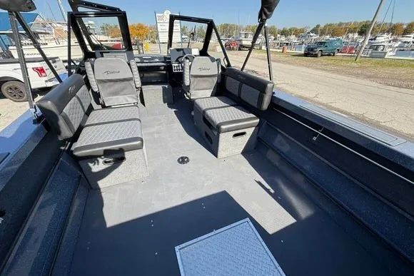 Slide: The Image of 2025 Weldcraft 210 Revolution boat interior with seating, docked at a marina. - 15