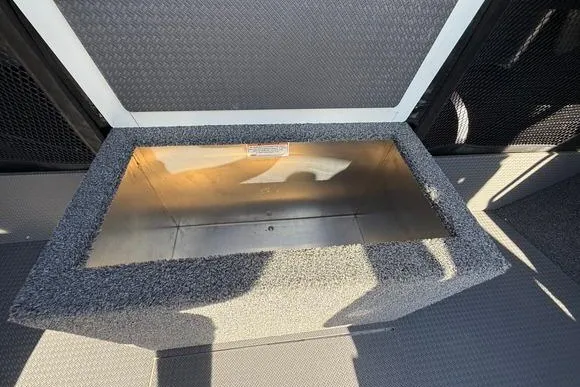 Slide: The Image of Storage compartment in 2025 Weldcraft 210 Revolution boat, featuring a durable, carpeted interior. - 32
