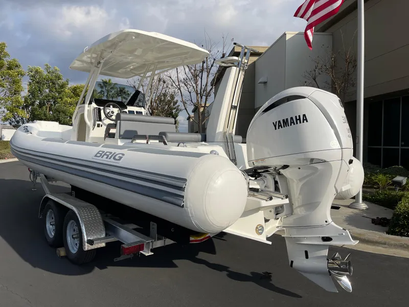 Slide: The Image of 2025 Brig Eagle 8 boat on trailer with Yamaha engine, parked outdoors. - 1