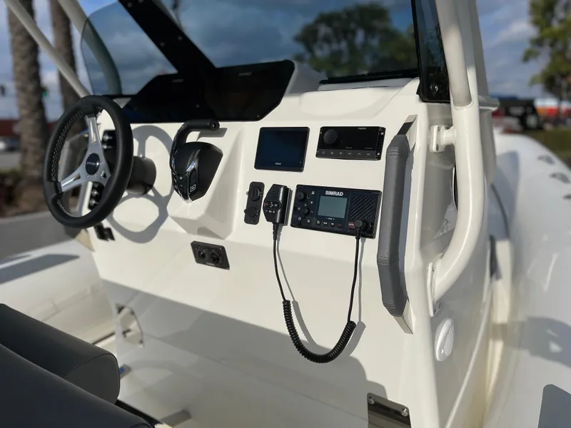 Slide: The Image of 2025 Brig Eagle 8 boat dashboard with steering wheel and navigation controls. - 4