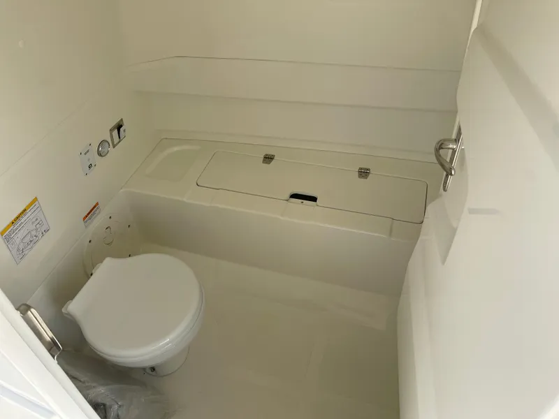 Slide: The Image of 2025 Brig Eagle 8 boat interior bathroom with compact toilet and storage compartment. - 7