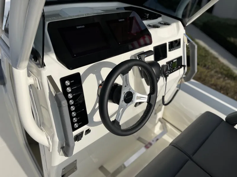 Slide: The Image of 2025 Brig Eagle 8 boat dashboard with steering wheel and control panels. - 9
