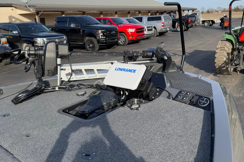 Slide: The Image of Fishing boat deck with Lowrance equipment, surrounded by parked vehicles, iKon LX20, 2024 model. - 10
