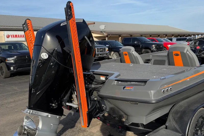 Slide: The Image of 2024 iKon LX20 boat with powerful outboard motor, parked in dealership lot. - 11