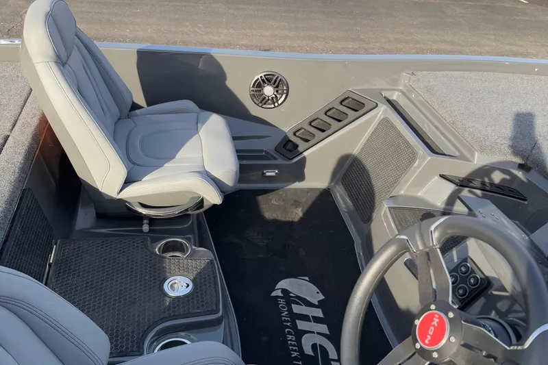 Slide: The Image of 2024 iKon LX20 boat interior with gray seating and steering wheel. - 15