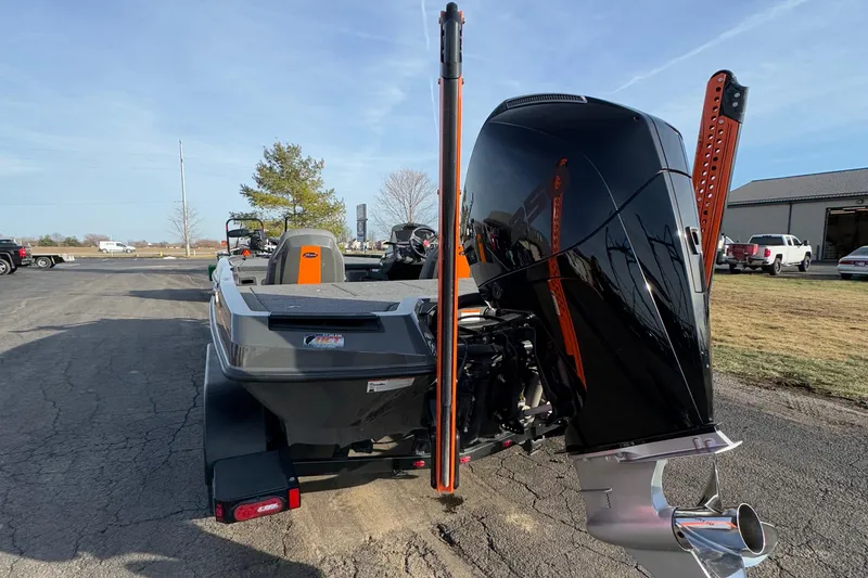 Slide: The Image of 2024 iKon LX20 boat with powerful outboard motor, parked outdoors on a sunny day. - 16