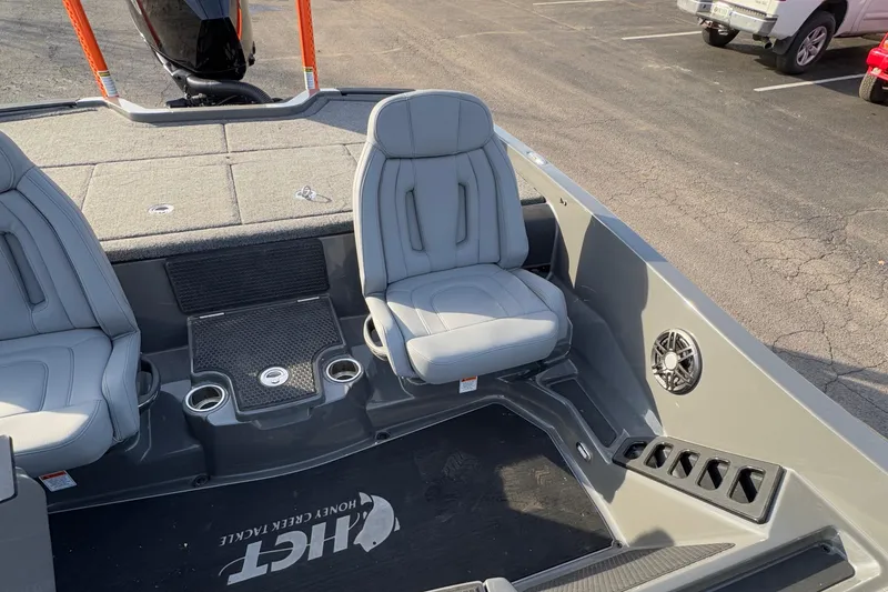 Slide: The Image of 2024 iKon LX20 boat interior with gray seats and cup holders. - 18