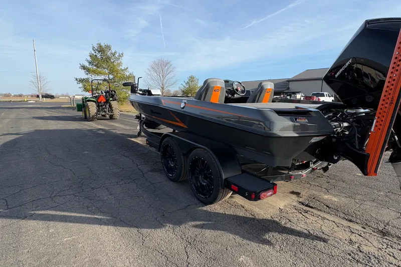 Slide: The Image of 2024 iKon LX20 boat on trailer, parked outdoors, with tractor in background. - 19