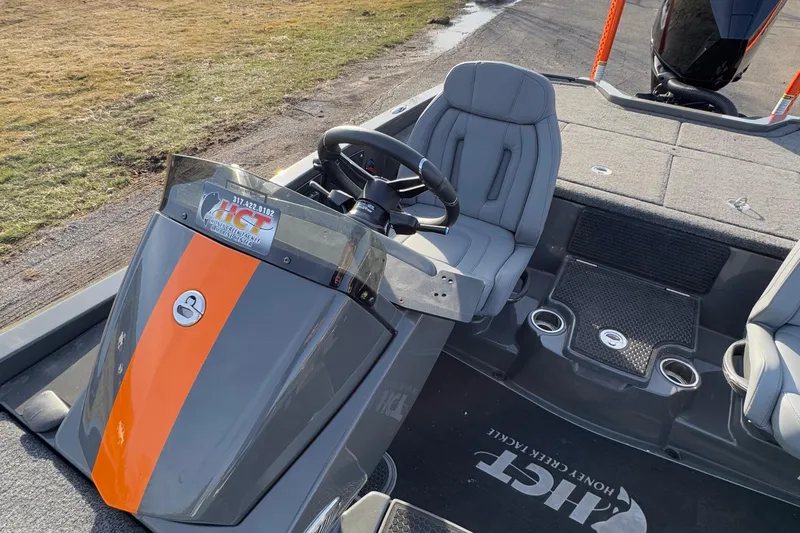 Slide: The Image of 2024 iKon LX20 boat interior with steering wheel and seating, featuring sleek design and orange accents. - 20