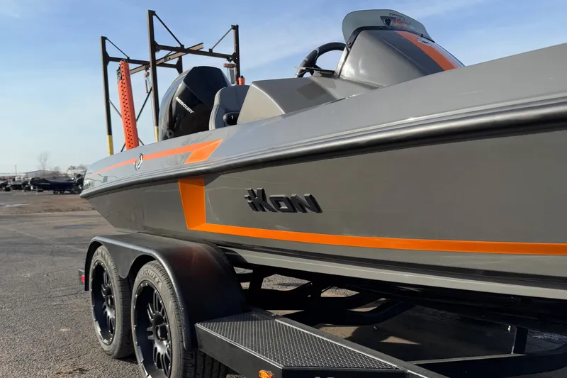 Slide: The Image of 2024 iKon LX20 boat with sleek gray and orange design on a trailer. - 5