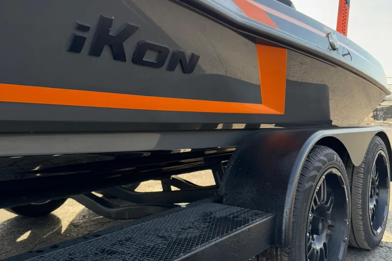 Slide: The Image of 2024 iKon LX20 boat with orange accents on a trailer, showcasing sleek design. - 7