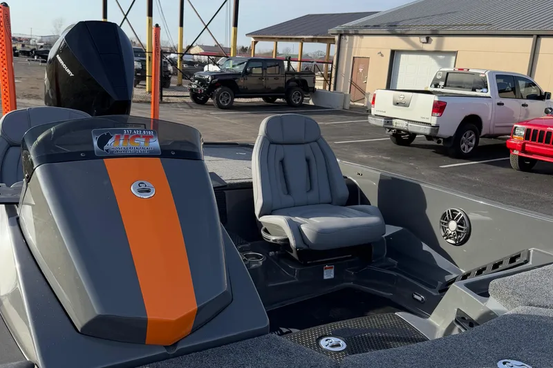 Slide: The Image of 2024 iKon LX20 boat with gray and orange design, parked in a lot. - 9