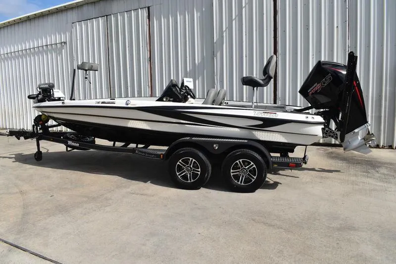 The Image of 2025 Triton 19 TrX Patriot boat on trailer, parked outdoors. - 0
