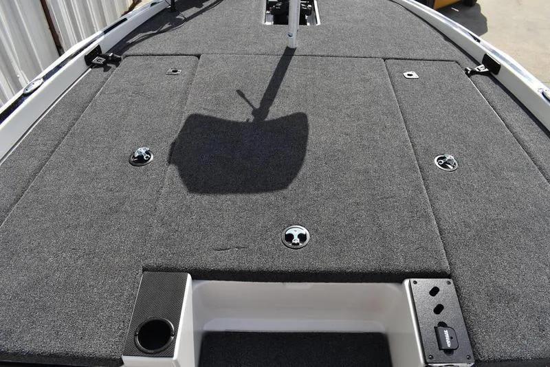 Slide: The Image of 2025 Triton 19 TrX Patriot boat deck with carpeted surface and storage compartments. - 11