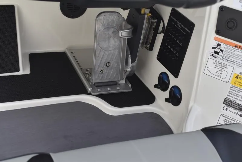 Slide: The Image of Interior view of 2025 Triton 19 TrX Patriot boat, featuring control panel and foot pedal. - 18