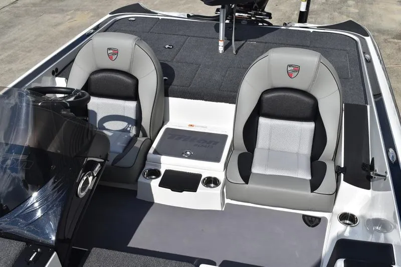 Slide: The Image of 2025 Triton 19 TrX Patriot boat interior with dual seats and steering console. - 20