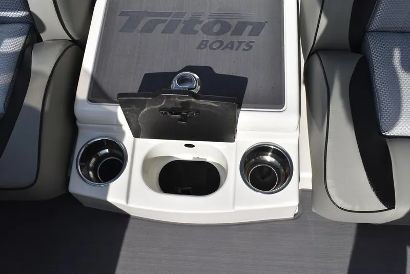 Slide: The Image of 2025 Triton 19 TrX Patriot boat interior with cup holders and storage compartment. - 22