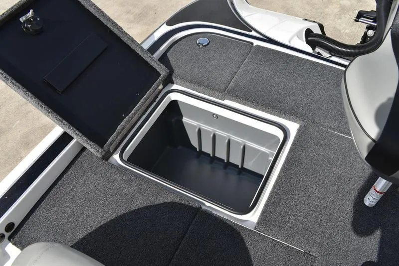 Slide: The Image of 2025 Triton 19 TrX Patriot boat storage compartment with open lid, showcasing interior space. - 24