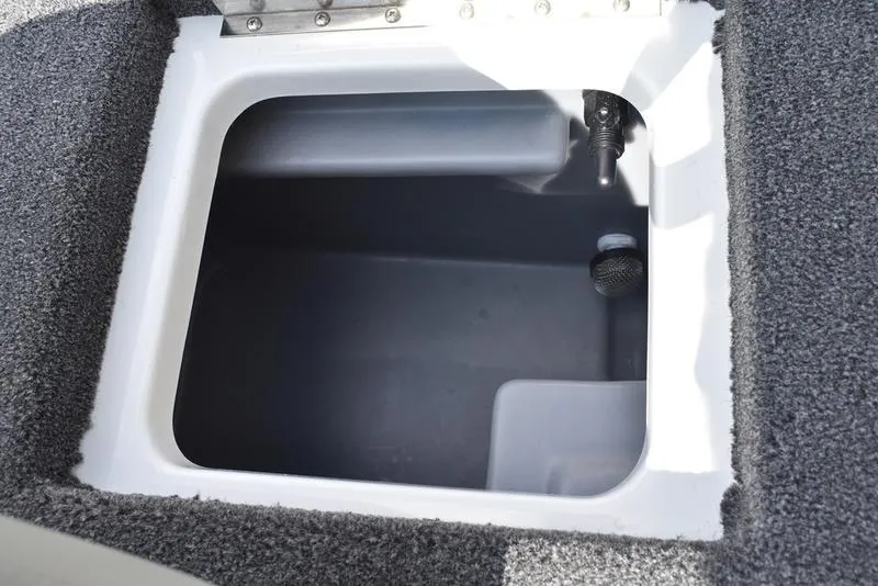 Slide: The Image of 2025 Triton 19 TrX Patriot boat storage compartment, open and empty. - 25