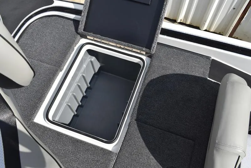 Slide: The Image of 2025 Triton 19 TrX Patriot boat storage compartment with open lid, showcasing interior space. - 27