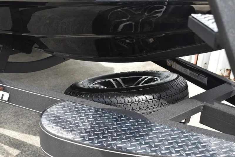 Slide: The Image of 2025 Triton 19 TrX Patriot trailer with spare tire and diamond plate step. - 6