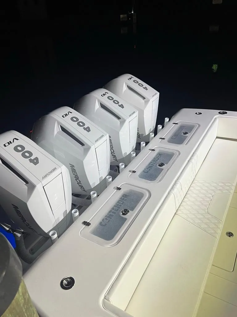 Slide: The Image of 2023 Contender 44 ST boat with four powerful outboard engines. - 1