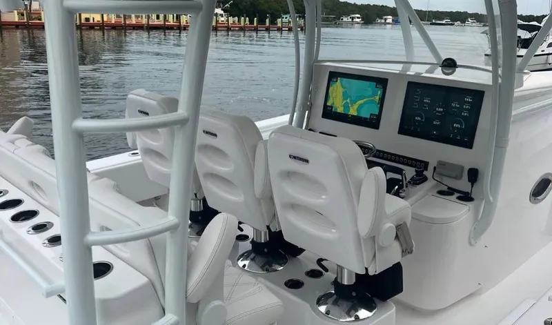 Slide: The Image of 2023 Contender 44 ST boat cockpit with dual seats and navigation screens. - 3