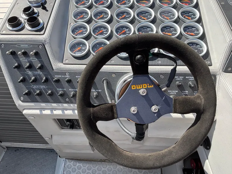 Slide: The Image of Steering wheel and dashboard of a 1994 Apache 47 Fire Water boat. - 10