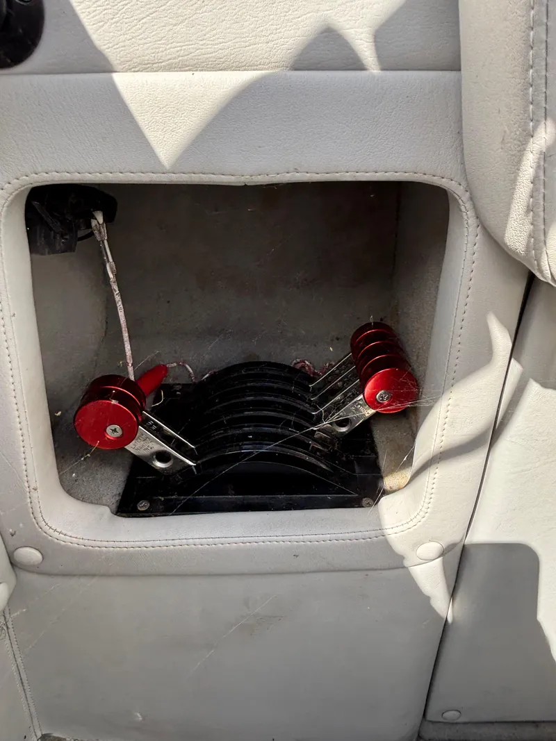 Slide: The Image of Interior view of a 1994 Apache 47 Fire Water boat with red mechanical components. - 12