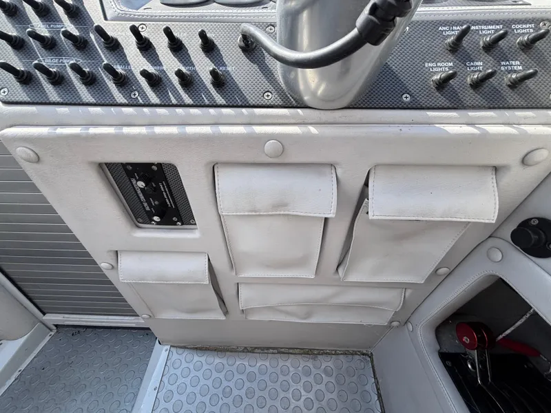 Slide: The Image of Control panel of a 1994 Apache 47 Fire Water boat with storage pouches. - 13