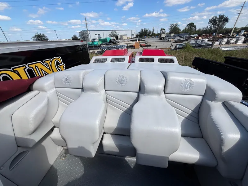 Slide: The Image of Interior seating of a 1994 Apache 47 Fire Water boat, featuring white leather upholstery. - 15
