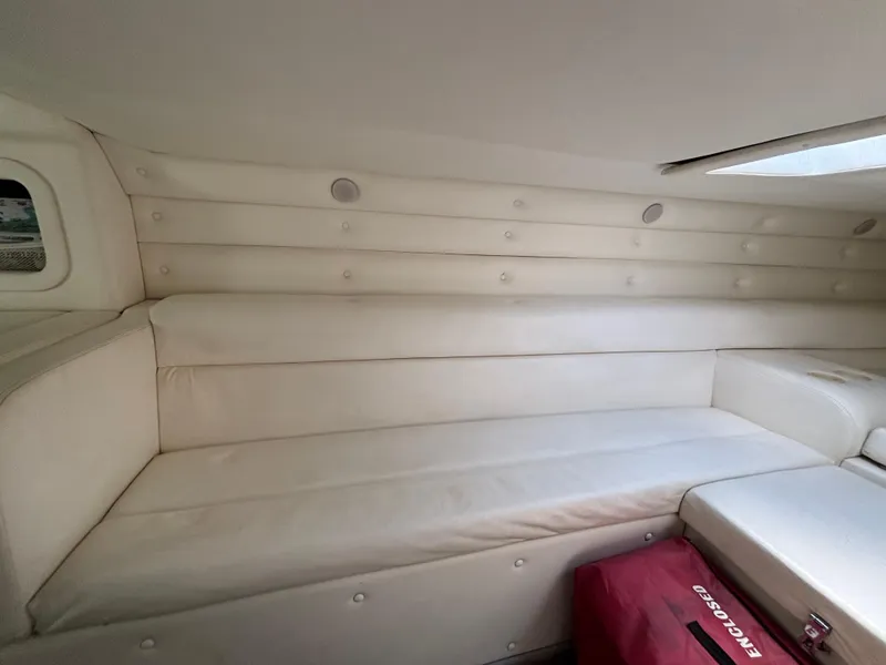 Slide: The Image of Interior of a 1994 Apache 47 Fire Water boat with white cushioned seating. - 19