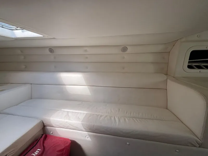 Slide: The Image of Interior of a 1994 Apache 47 Fire Water boat with white cushioned seating. - 20