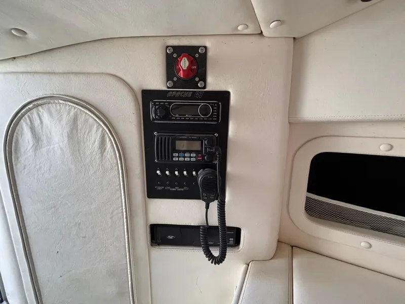 Slide: The Image of Interior of a 1994 Apache 47 Fire Water boat with radio and control panel. - 23